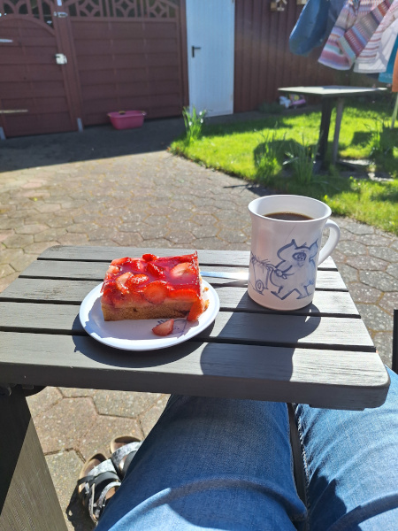 Teller mit Erdbeerkuchen und Kaffeetasse